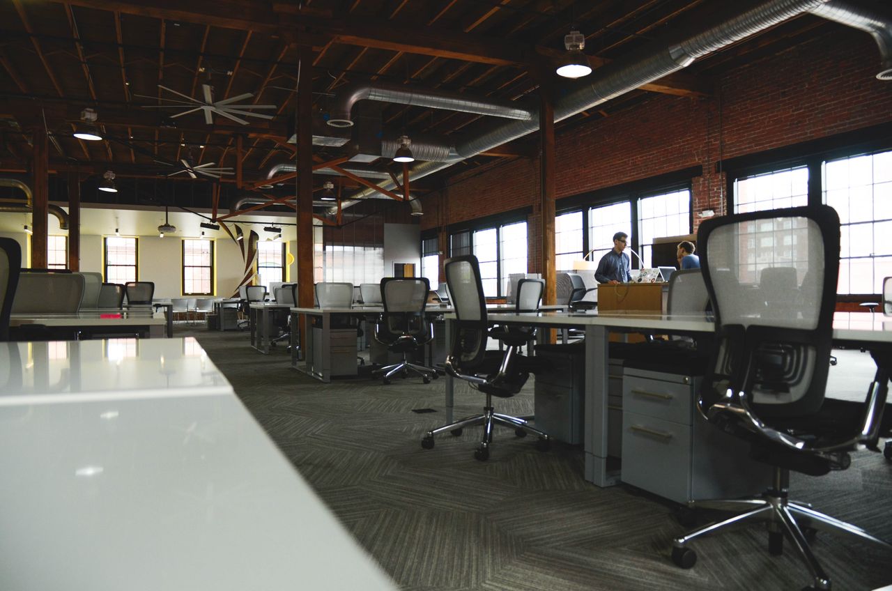 our-mission Open-plan industrial coworking space with modern design and natural lighting.